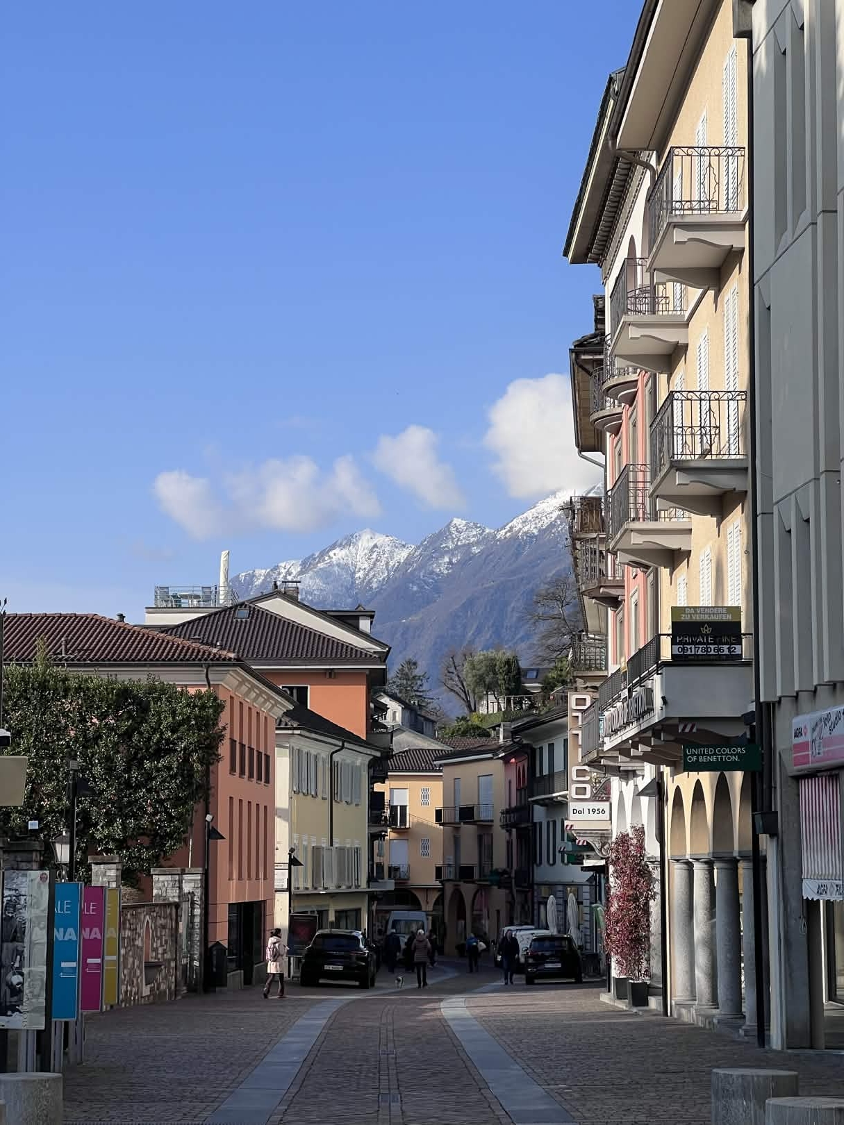 Street view in Ascona with the mountains beyond